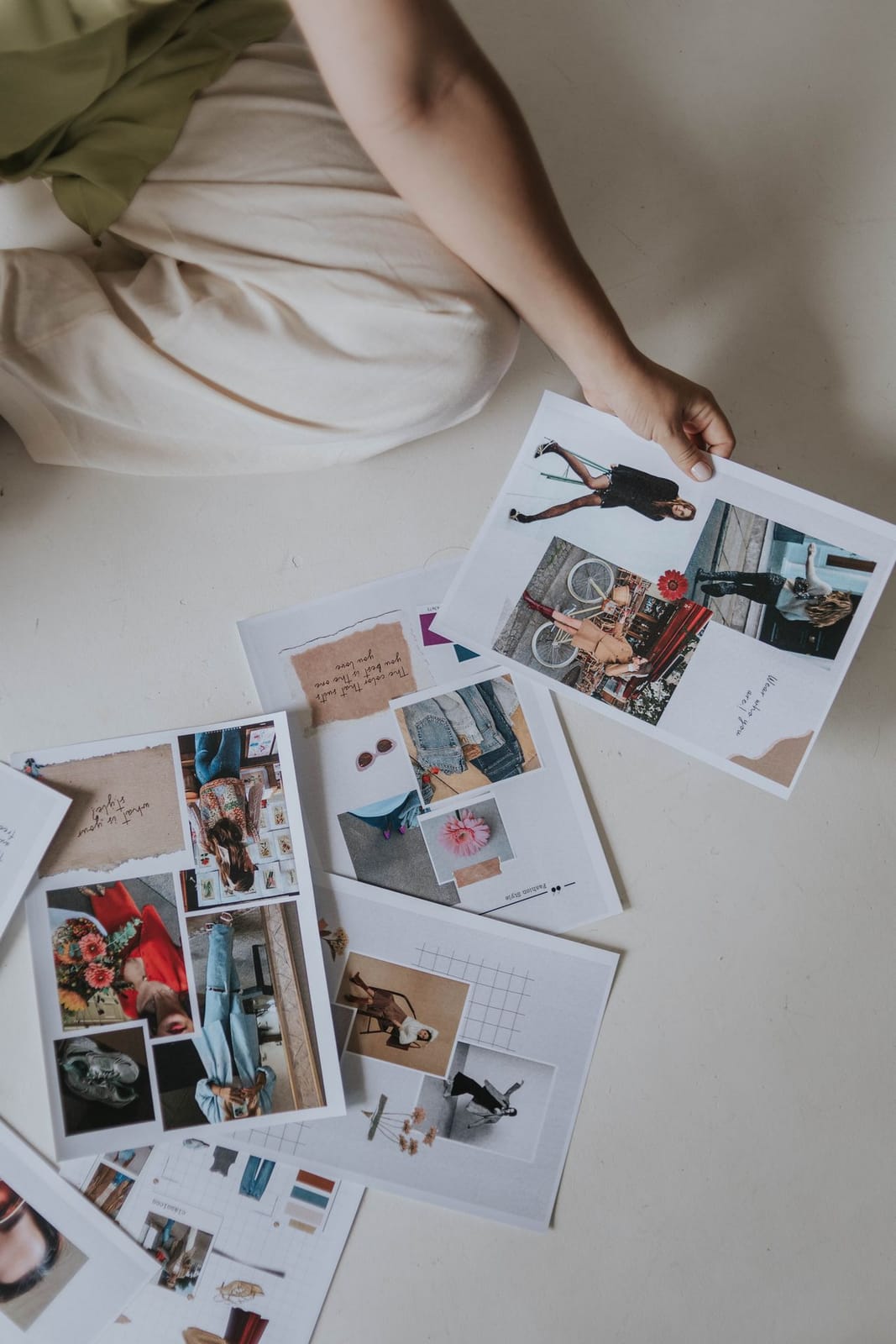 A colourful set of printed fashion mood board examples laid out on the floor