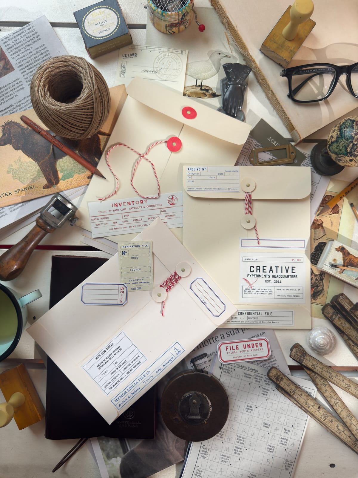 A flatlay 'inspiration file' of collected references, envelopes, and ephemera for a mood board