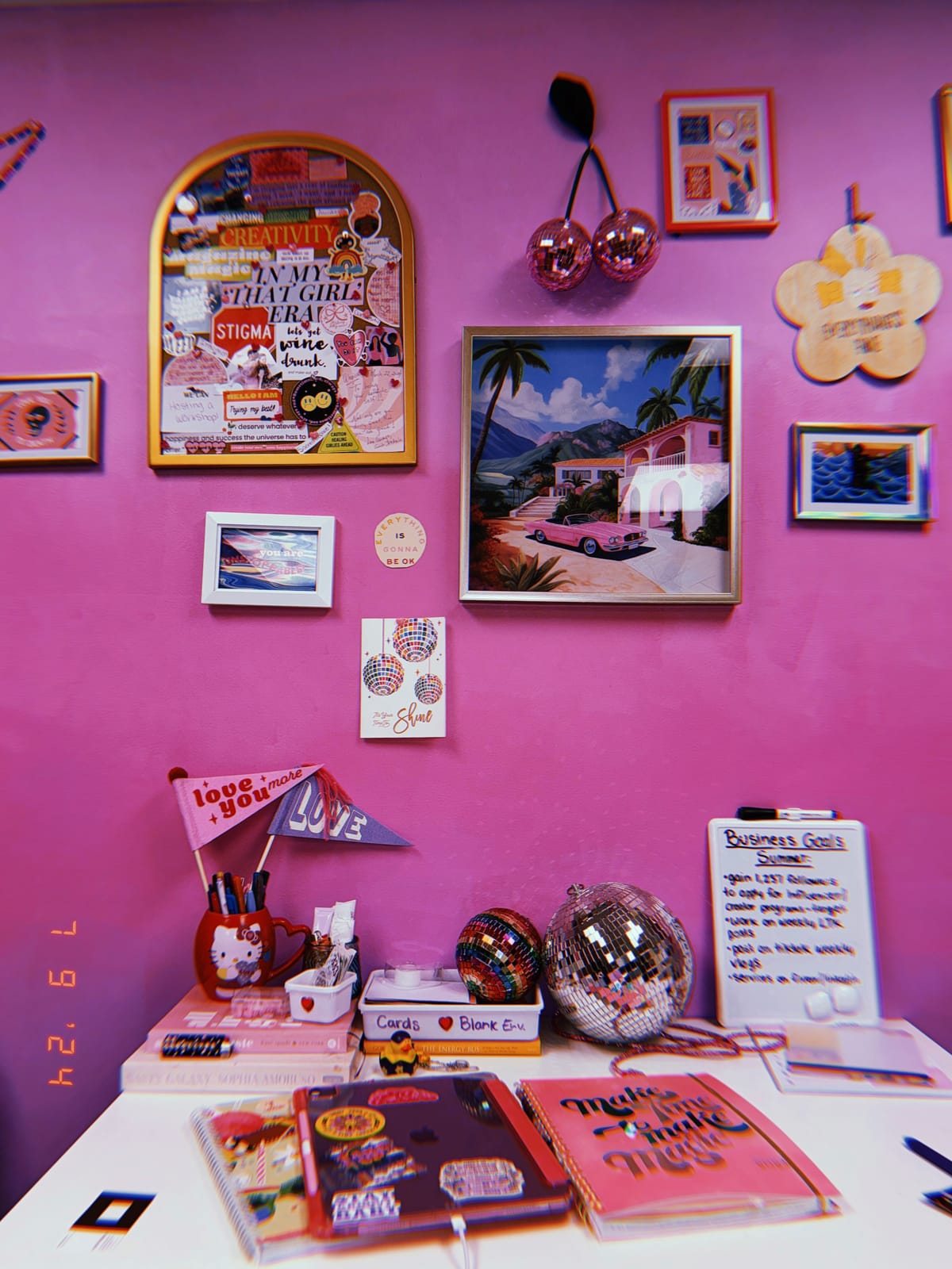 A colourful, maximalist vision board wall with a goals list