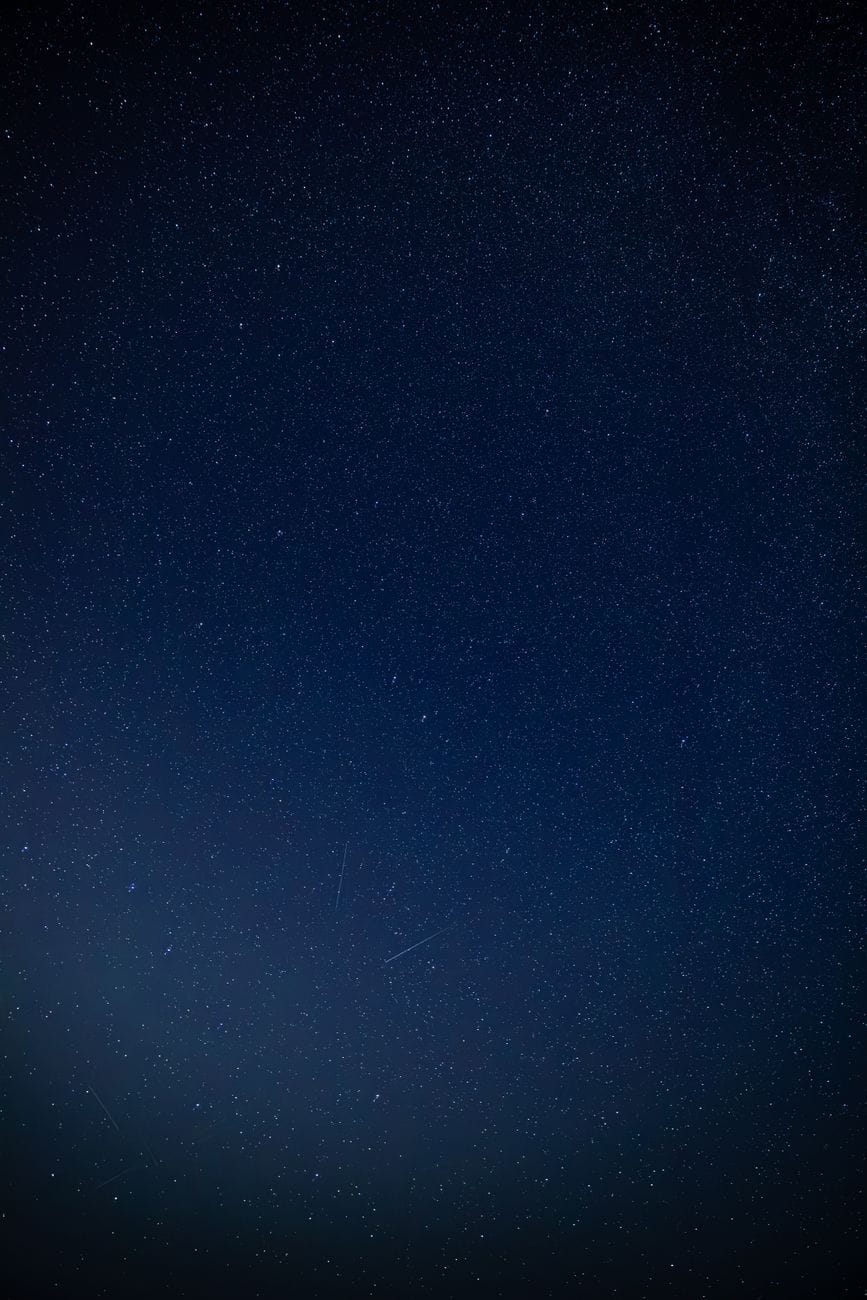A deep blue star-filled night sky